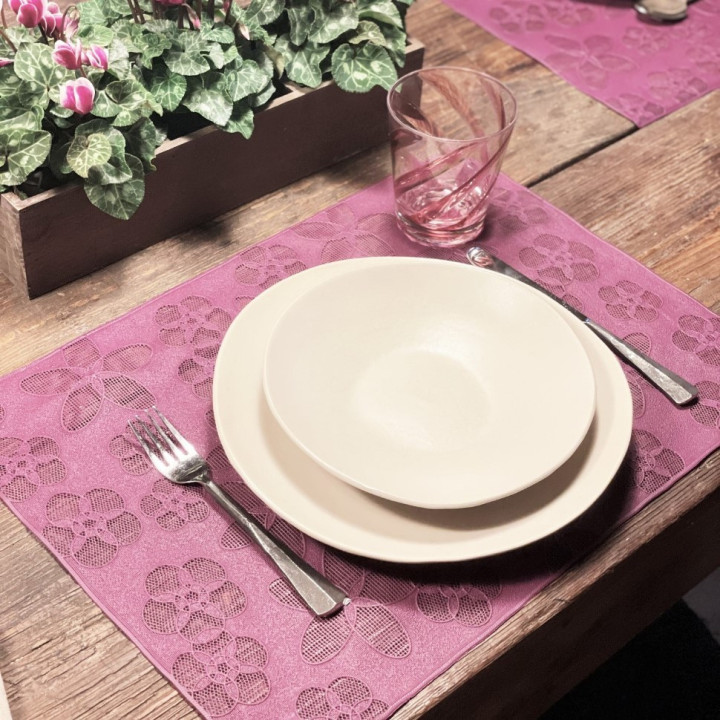 Plastic placemat with drilled flowers