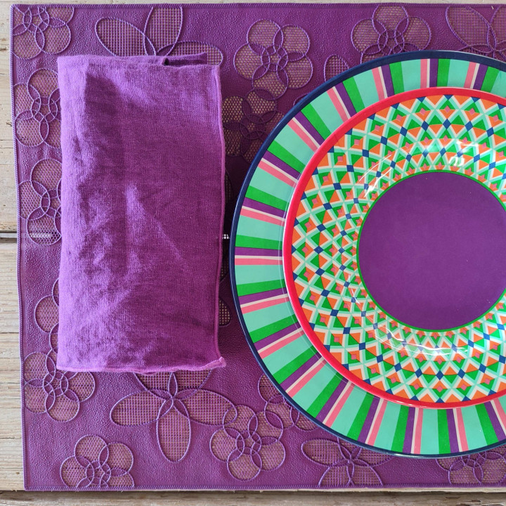 Plastic placemat with drilled flowers